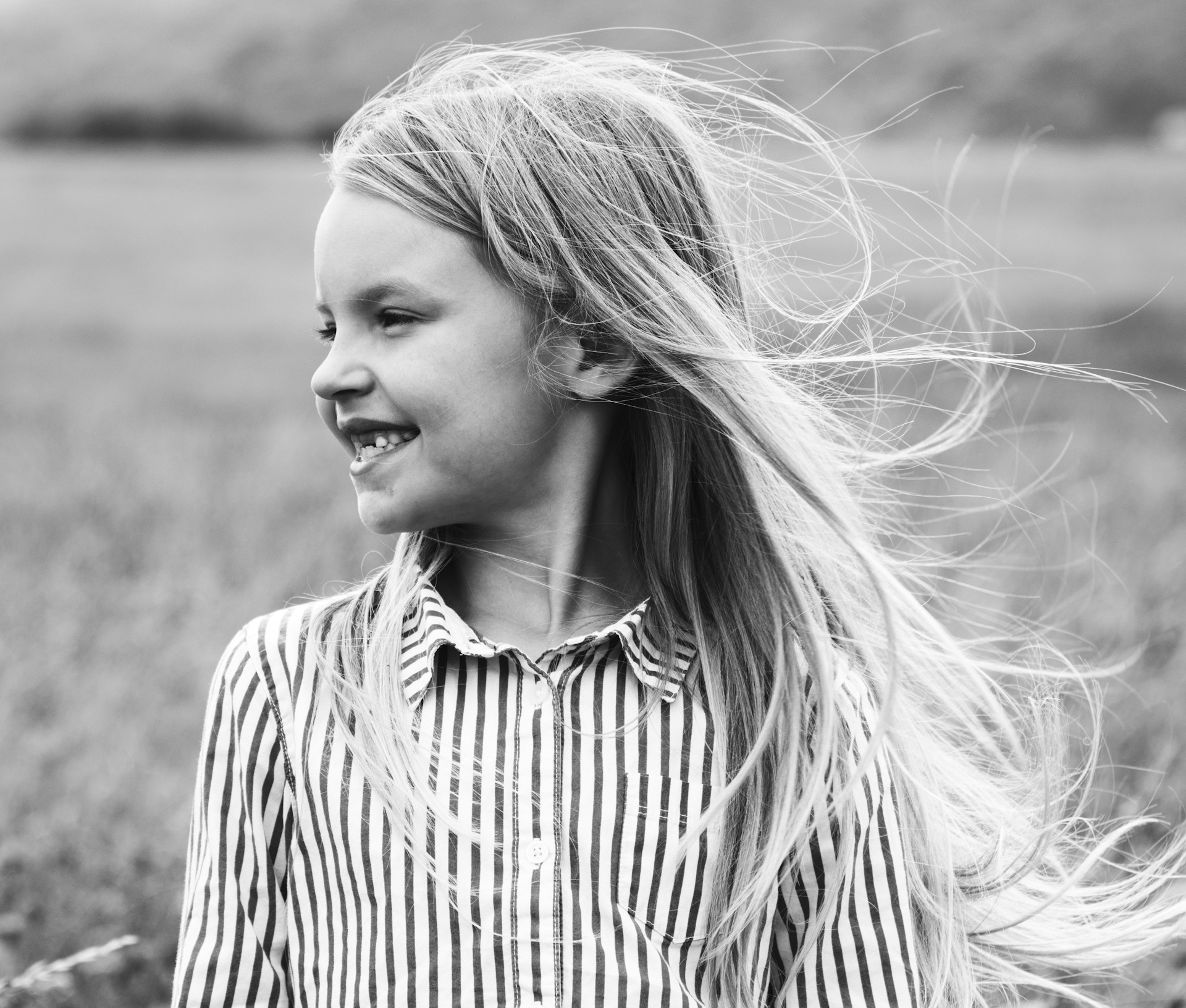 Example keepsake cover: a girl laughing with windblown hair